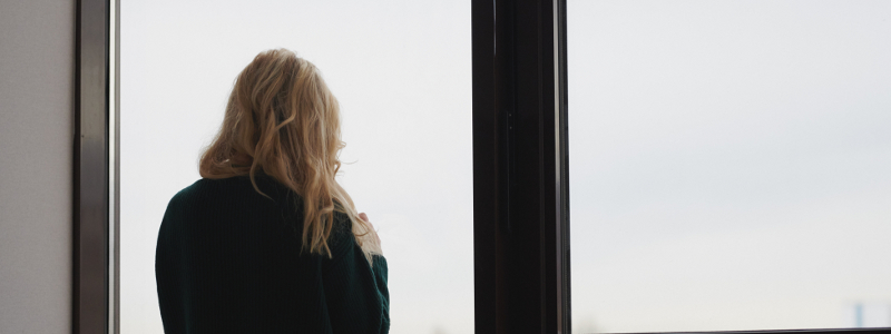 Southern Cross - A woman looks out of a window alone A woman looks out of a window alone