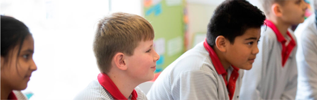 Four boys sitting in class