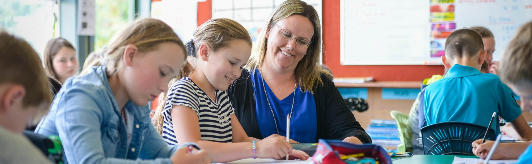 Children write with their teacher
