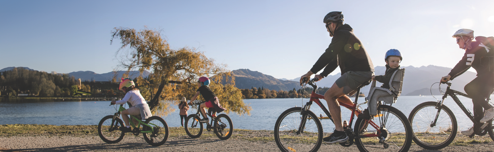Family on bikes by the lake