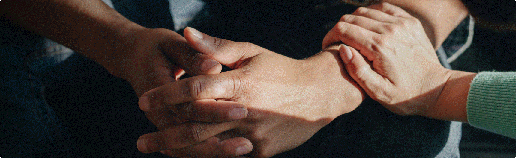 People holding hands in support