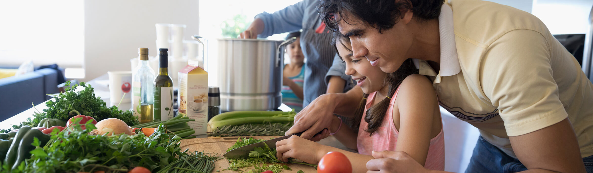 Southern Cross - A father and daughter are chopping vegetables together in the kitchen A father and daughter are chopping vegetables together in the kitchen