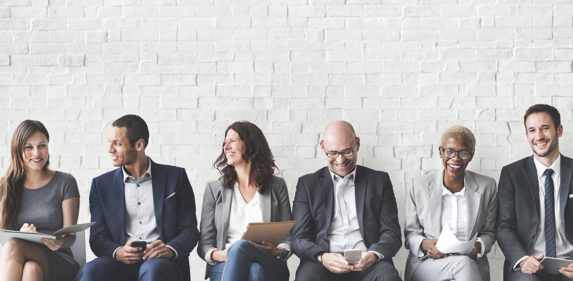 Southern Cross - Colleagues sat in a line talk and laugh Colleagues sat in a line talk and laugh