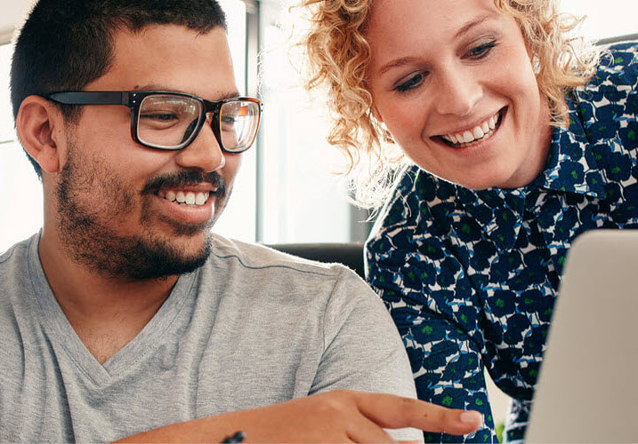 Southern Cross in your workplace Two work colleagues looking at a laptop screen