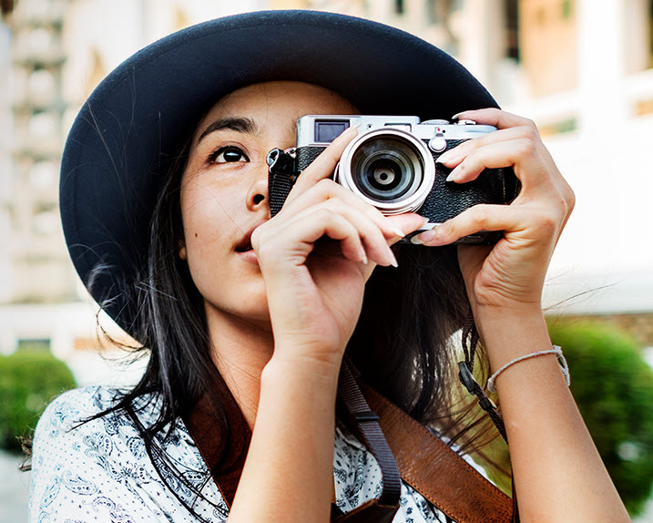 A woman on holiday in Asia, taking a photo of her surroundings